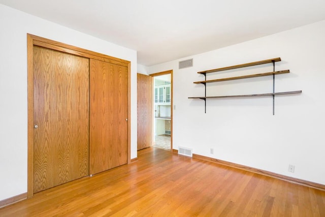 1313 S 26th St, Manitowoc, WI 54220 - unfurnished bedroom featuring light wood-style floors and a closet