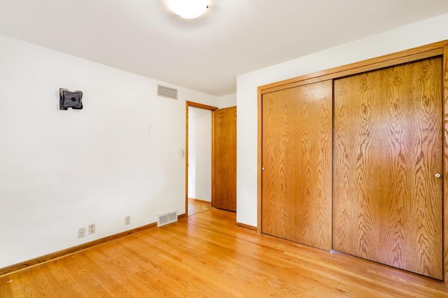1313 S 26th St, Manitowoc, WI 54220 - unfurnished bedroom with light wood-style flooring and a closet