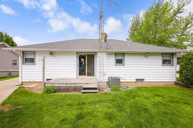 1313 S 26th St, Manitowoc, WI 54220 - rear view of house featuring a lawn, a wooden deck, a chimney, and a shingled roof