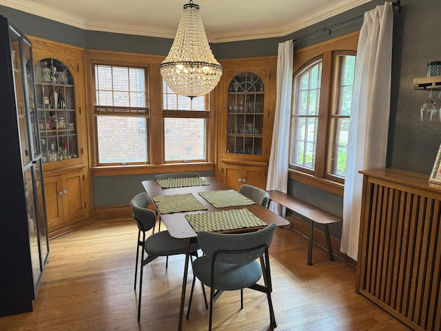 6309 W Mckinley Ave, Wauwatosa, WI 53213 - dining area with light wood-style flooring, a chandelier, and crown molding