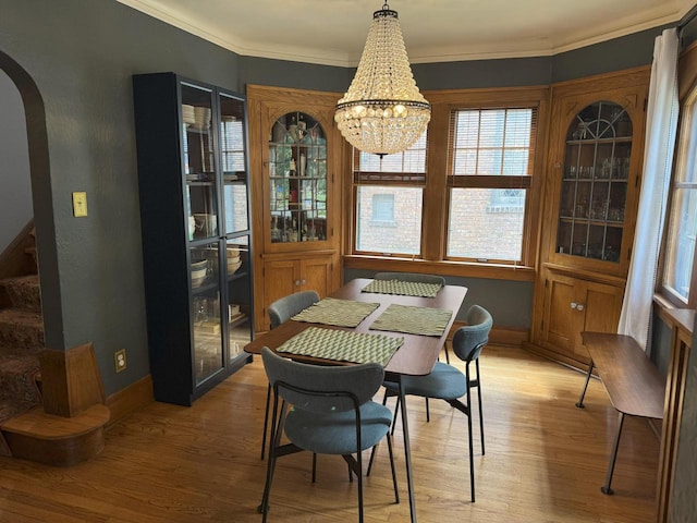 6309 W Mckinley Ave, Wauwatosa, WI 53213 - dining room with arched walkways, wood finished floors, crown molding, a chandelier, and stairway
