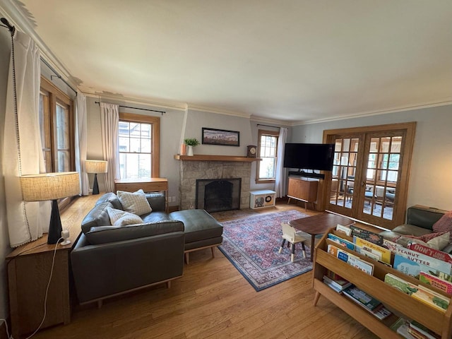 6309 W Mckinley Ave, Wauwatosa, WI 53213 - living area featuring wood finished floors, ornamental molding, french doors, and a fireplace with flush hearth