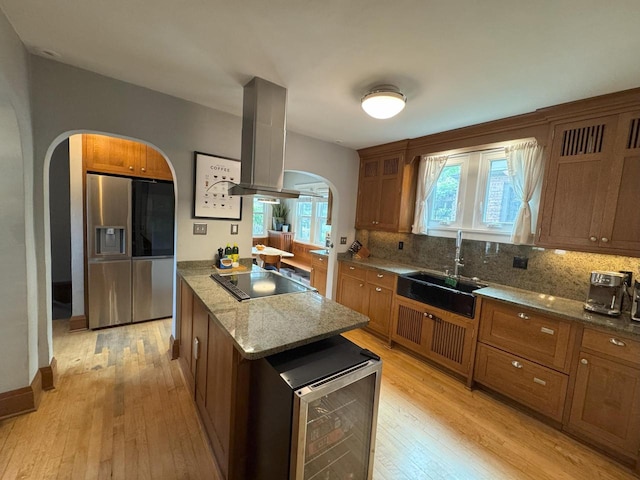 6309 W Mckinley Ave, Wauwatosa, WI 53213 - kitchen featuring stainless steel refrigerator with ice dispenser, range hood, arched walkways, black electric cooktop, and light wood-style floors