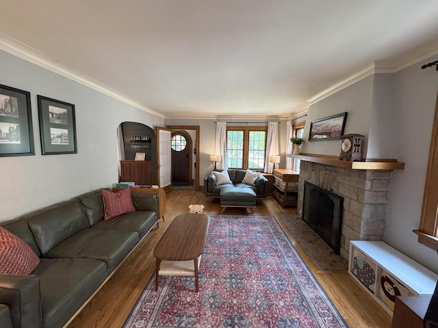 6309 W Mckinley Ave, Wauwatosa, WI 53213 - living area with light wood finished floors, a fireplace, crown molding, and arched walkways