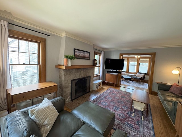 6309 W Mckinley Ave, Wauwatosa, WI 53213 - living room featuring wood finished floors, a stone fireplace, and ornamental molding