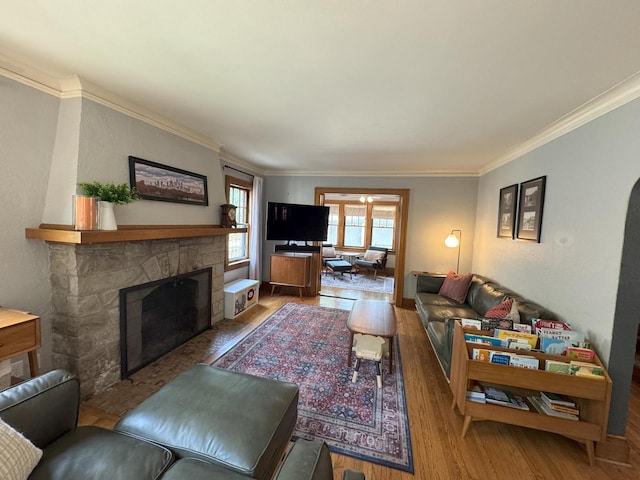 6309 W Mckinley Ave, Wauwatosa, WI 53213 - living room with wood finished floors, crown molding, and a stone fireplace