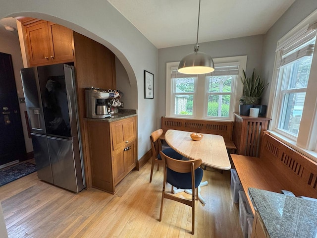 6309 W Mckinley Ave, Wauwatosa, WI 53213 - dining space with arched walkways, light wood-type flooring, and radiator