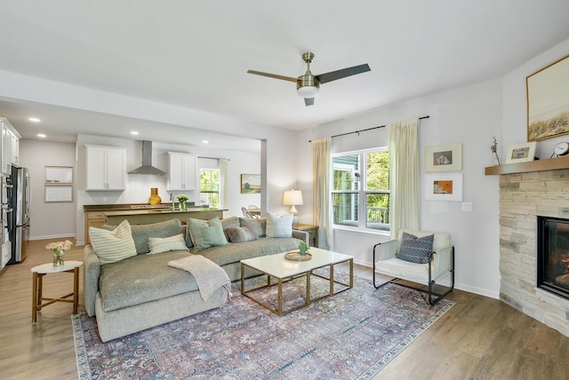 309 Paradise Ct, Hartland, WI 53029 - living area featuring light wood-style flooring, a ceiling fan, a fireplace, and recessed lighting