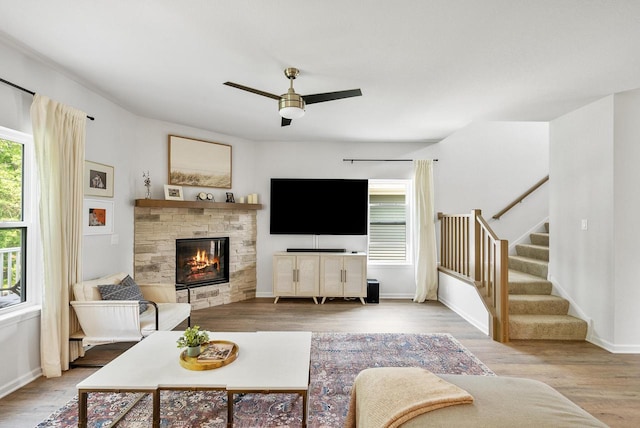 309 Paradise Ct, Hartland, WI 53029 - living room featuring ceiling fan, stairway, wood finished floors, and a fireplace