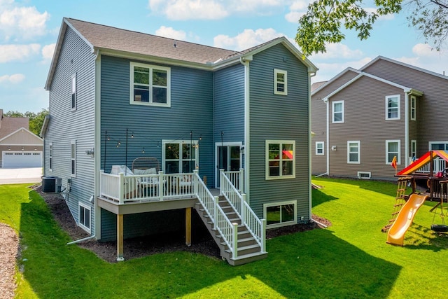 309 Paradise Ct, Hartland, WI 53029 - back of property with a playground, a yard, a wooden deck, and stairs