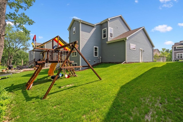 309 Paradise Ct, Hartland, WI 53029 - rear view of property with a playground and a yard