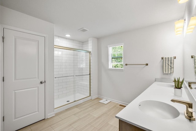 309 Paradise Ct, Hartland, WI 53029 - full bath with double vanity, a stall shower, and recessed lighting