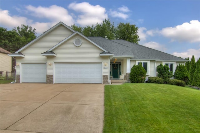 3614 Greendale Ct, Eau Claire, WI 54701 - view of front of property with concrete driveway, a front yard, an attached garage, and stone siding