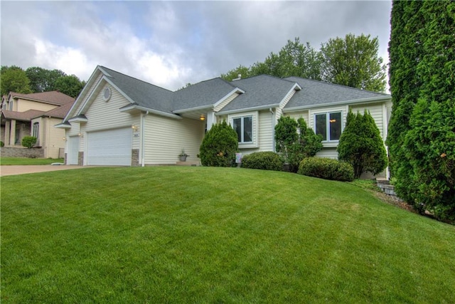 3614 Greendale Ct, Eau Claire, WI 54701 - view of front of house featuring a front yard, an attached garage, concrete driveway, and roof with shingles
