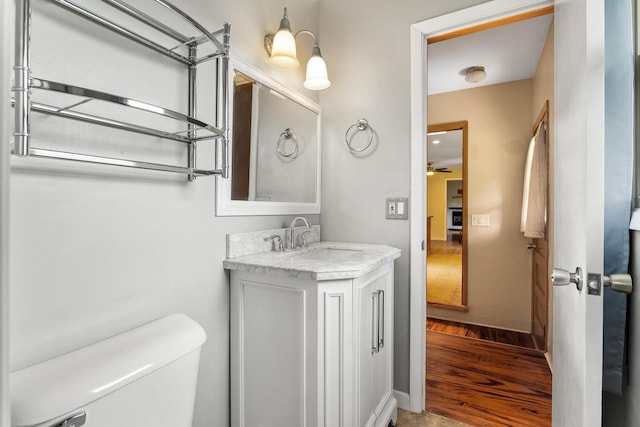 1635 N 21st St, Manitowoc, WI 54220 - half bathroom featuring vanity, wood finished floors, and ceiling fan