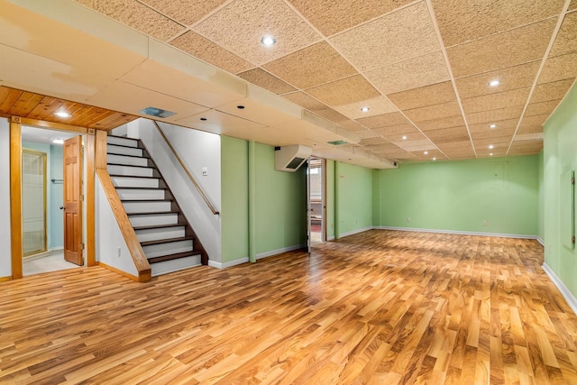 1635 N 21st St, Manitowoc, WI 54220 - finished basement featuring light wood-type flooring, a wall mounted AC, stairs, and recessed lighting