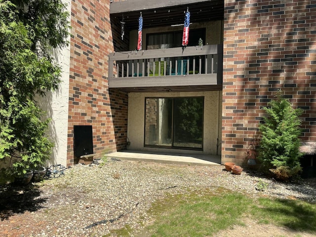 2200 W Good Hope Rd Unit 115, Glendale, WI 53209 - property entrance featuring a balcony and brick siding