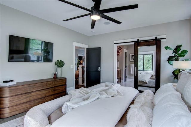 6649 Hope Ln, Eau Claire, WI 54701 - bedroom featuring a barn door and ceiling fan