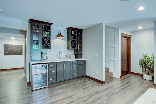 6649 Hope Ln, Eau Claire, WI 54701 - indoor wet bar with wine cooler, decorative backsplash, light wood-type flooring, stairway, and recessed lighting