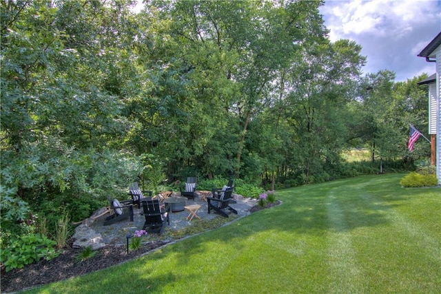6649 Hope Ln, Eau Claire, WI 54701 - view of green lawn featuring an outdoor fire pit and a patio