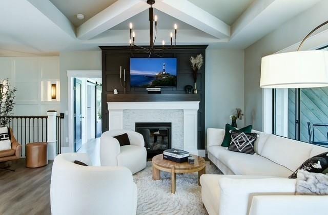 6649 Hope Ln, Eau Claire, WI 54701 - living area with a chandelier, wood finished floors, beam ceiling, and a fireplace