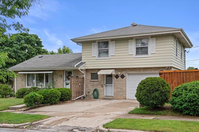 9230 W Auer Ave, Milwaukee, WI 53222 - tri-level home featuring a garage, brick siding, and driveway