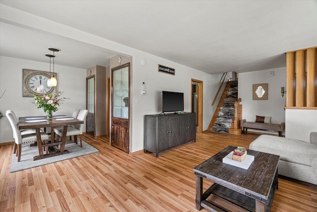 9230 W Auer Ave, Milwaukee, WI 53222 - living room featuring light wood-style floors, stairs, and a chandelier