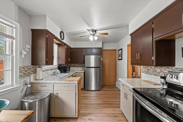 9230 W Auer Ave, Milwaukee, WI 53222 - kitchen with appliances with stainless steel finishes, light countertops, ceiling fan, and light wood-type flooring