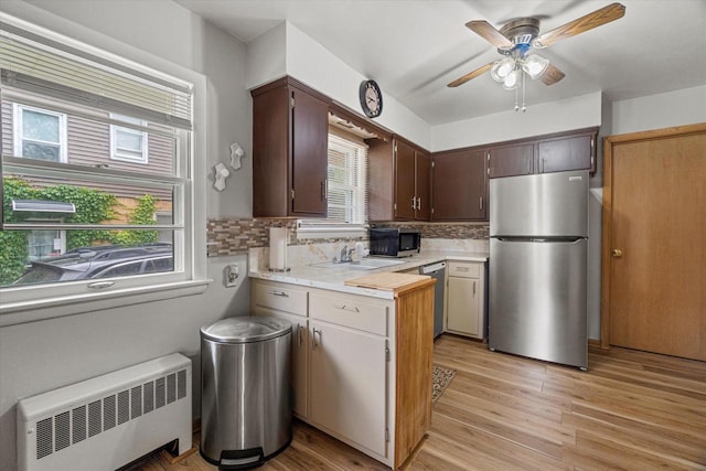 9230 W Auer Ave, Milwaukee, WI 53222 - kitchen featuring stainless steel appliances, radiator heating unit, plenty of natural light, and light countertops