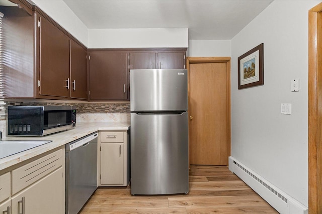 9230 W Auer Ave, Milwaukee, WI 53222 - kitchen featuring stainless steel appliances, baseboard heating, light countertops, and light wood finished floors