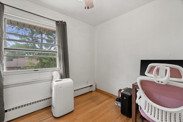 9230 W Auer Ave, Milwaukee, WI 53222 - home office with a baseboard radiator, light wood finished floors, and a ceiling fan