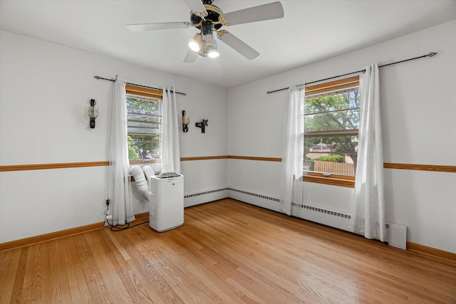 9230 W Auer Ave, Milwaukee, WI 53222 - spare room featuring light wood-style flooring, ceiling fan, and baseboard heating
