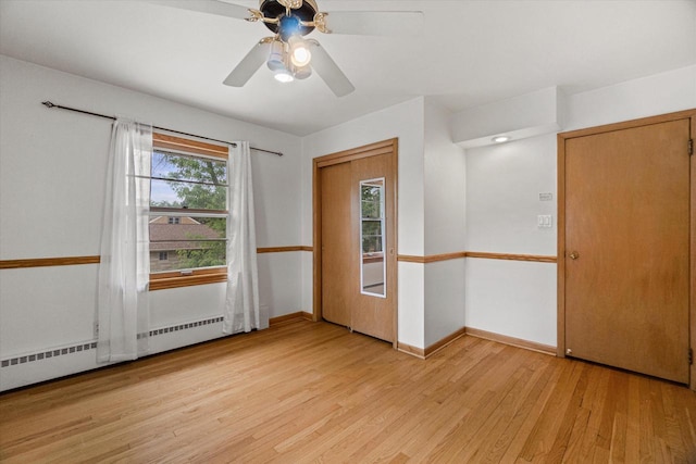 9230 W Auer Ave, Milwaukee, WI 53222 - unfurnished room with light wood-style floors, ceiling fan, and baseboard heating