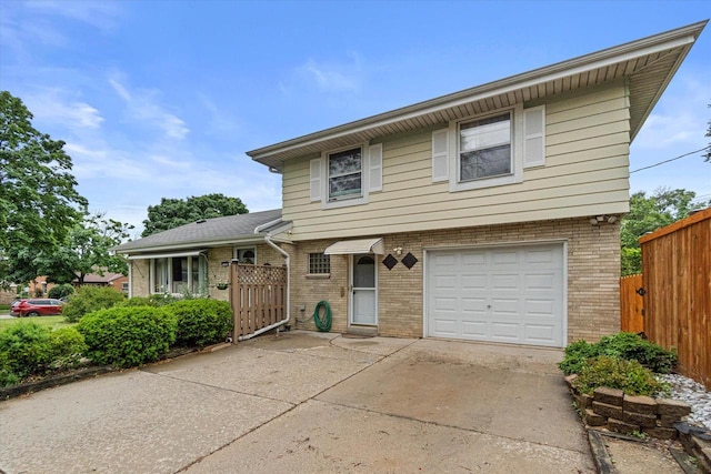 9230 W Auer Ave, Milwaukee, WI 53222 - view of front facade featuring brick siding, driveway, and an attached garage