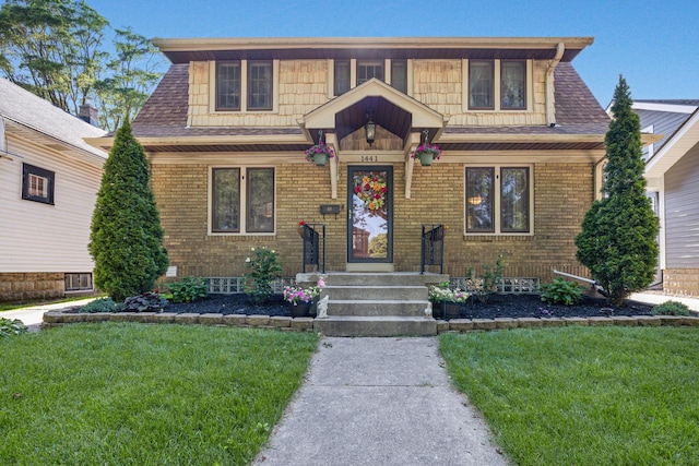 1441 N 66th St, Wauwatosa, WI 53213 - view of front of property with a front yard, brick siding, and roof with shingles