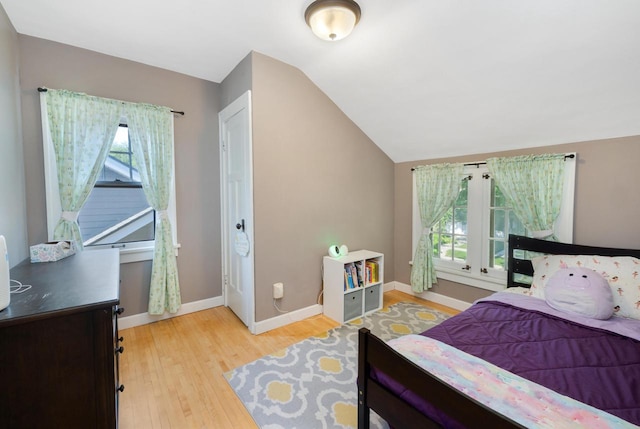 1441 N 66th St, Wauwatosa, WI 53213 - bedroom featuring multiple windows, light wood-style floors, and lofted ceiling