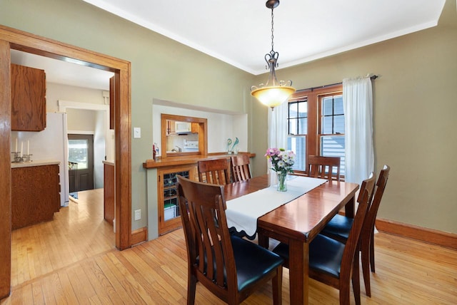 1441 N 66th St, Wauwatosa, WI 53213 - dining space featuring light wood-style floors and ornamental molding
