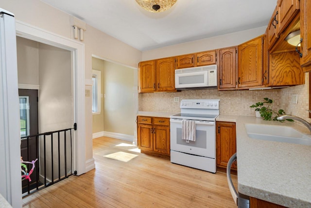 1441 N 66th St, Wauwatosa, WI 53213 - kitchen with white appliances, tasteful backsplash, and light countertops