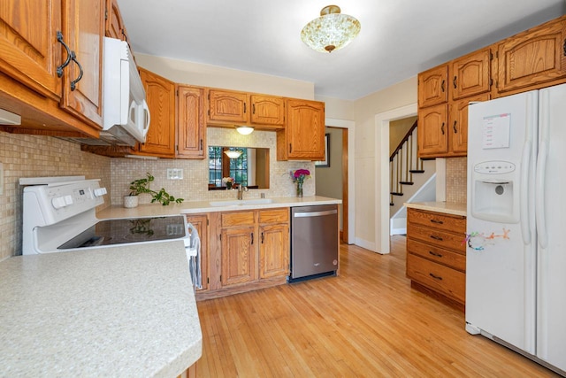 1441 N 66th St, Wauwatosa, WI 53213 - kitchen with white appliances, light countertops, and light wood-type flooring