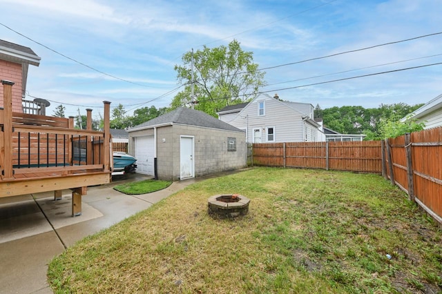203 N 71st St, Milwaukee, WI 53213 - fenced backyard featuring an outdoor fire pit, an outdoor structure, a garage, and a wooden deck