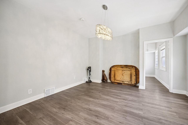 3936 N 14th St Unit 3938, Milwaukee, WI 53206 - unfurnished dining area featuring a chandelier and wood finished floors