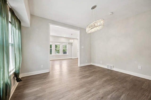 3936 N 14th St Unit 3938, Milwaukee, WI 53206 - unfurnished room with a chandelier, wood finished floors, and a smoke detector