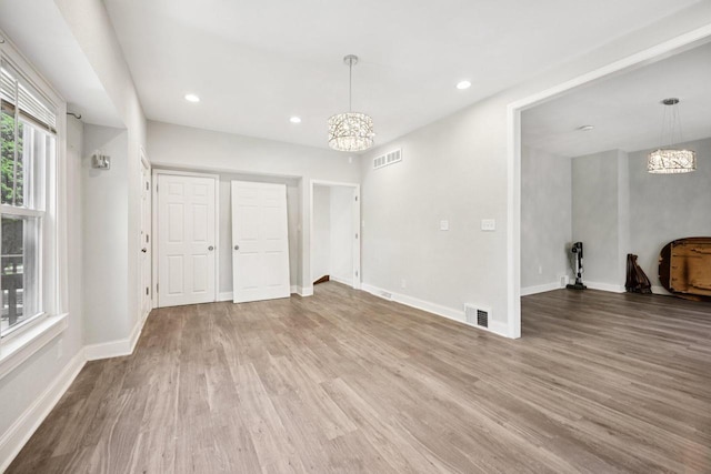 3936 N 14th St Unit 3938, Milwaukee, WI 53206 - unfurnished living room featuring a chandelier, wood finished floors, and recessed lighting