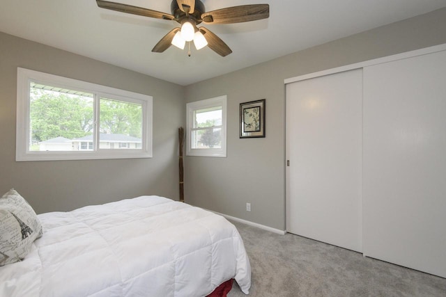 WW151N8656 Marshall Dr, Menomonee Falls, WI 53051 - bedroom with light colored carpet, a closet, and a ceiling fan