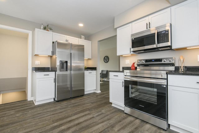WW151N8656 Marshall Dr, Menomonee Falls, WI 53051 - kitchen with appliances with stainless steel finishes, dark wood finished floors, dark countertops, white cabinetry, and recessed lighting