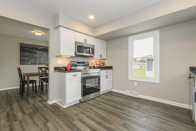 WW151N8656 Marshall Dr, Menomonee Falls, WI 53051 - kitchen featuring stainless steel appliances, dark wood-type flooring, dark countertops, white cabinets, and recessed lighting