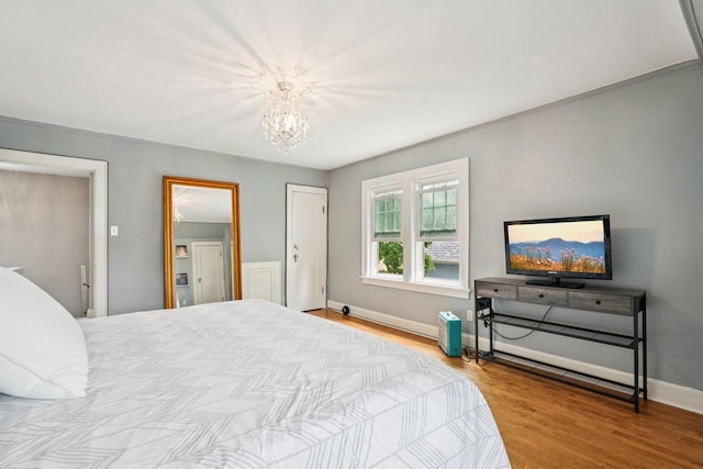 509 S 6th Ave, West Bend, WI 53095 - bedroom with a chandelier and wood finished floors