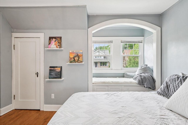 509 S 6th Ave, West Bend, WI 53095 - bedroom featuring wood finished floors and arched walkways