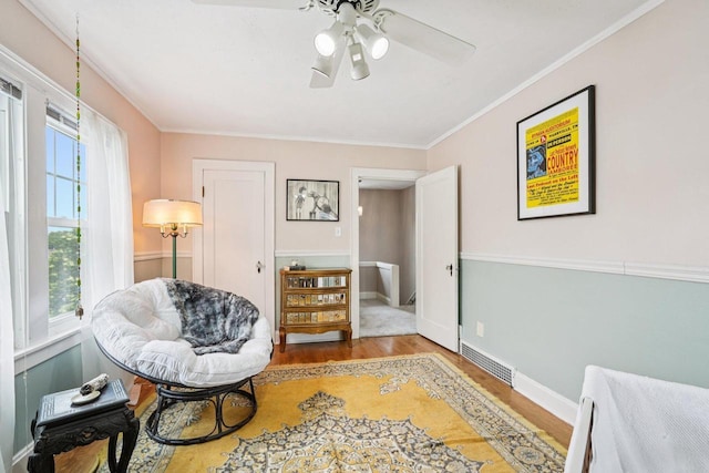 509 S 6th Ave, West Bend, WI 53095 - sitting room featuring wood finished floors, ceiling fan, and ornamental molding