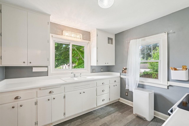 509 S 6th Ave, West Bend, WI 53095 - kitchen with light countertops, wood finished floors, white cabinetry, and range